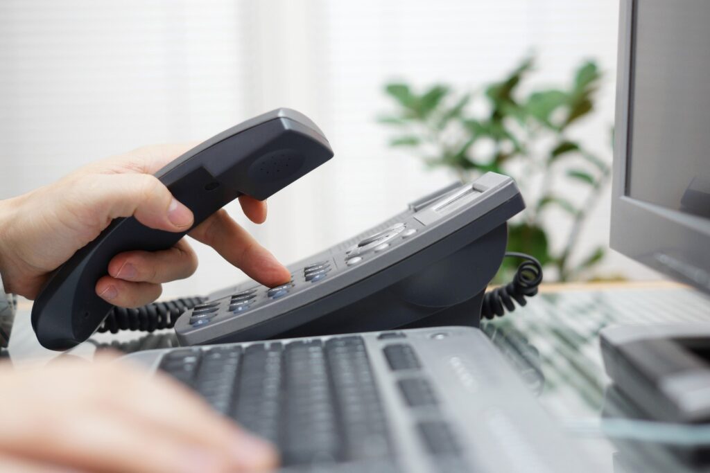 businessman is dialing a phone number in office